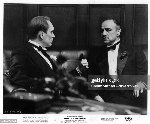Robert Duvall having a conversation with Marlon Brando in a scene from the film 'The Godfather', 1972.
