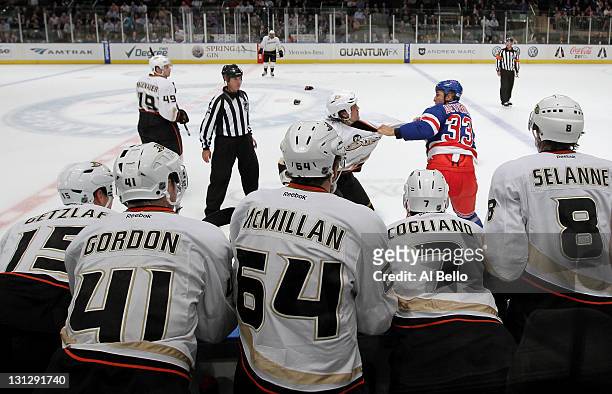 Andre Deveaux of the New York Rangers fights George Parros of the Anaheim Ducks by the Anaheim Ducks bench during their game on November 3, 2011 at...