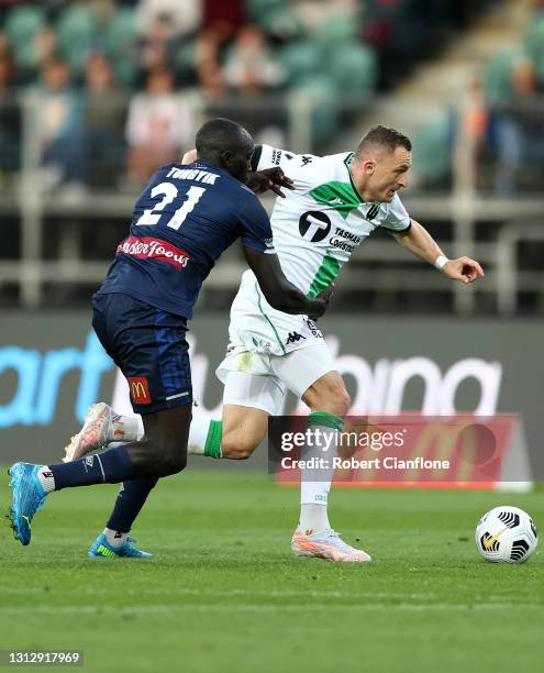 Besart Berisha of Western United is pressured by Ruon Tongyik of the Mariners during the A-League match between Western United FC and the Central...