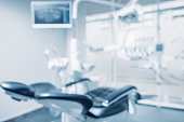 Defocused background and copy space image of dental office with dentist chair and equipment