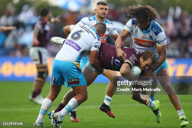 Jake Trbojevic of the Sea Eagles is tackled by Ashley Taylor and Kevin Proctor of the Titans during the round six NRL match between the Manly Sea...