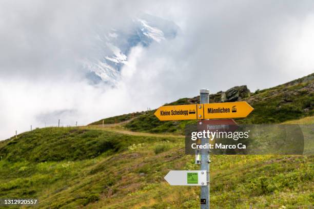 signposts for hikers on the panoramaweg in the jungfrau region - eiger stock pictures, royalty-free photos & images