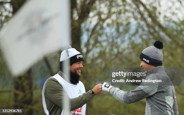 Matthias Schwab of Austria celebrates with his caddie James Baker after holing his third shot from a bunker on the 9th hole during Day Three of the...