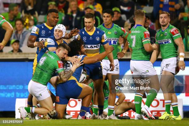 Isaiah Papali'i of the Eels celebrates with team mates after scoring a try during the round six NRL match between the Canberra Raiders and the...