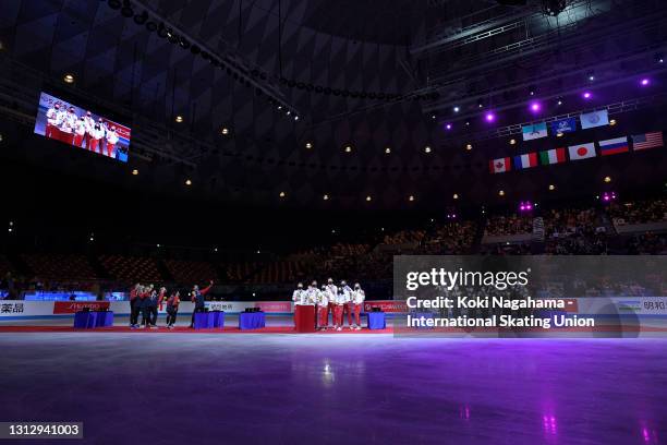 Silver medalist Team USA, gold medalist Team Russia and bronze medalist Team Japan pose at the medal ceremony on day three of ISU World Team Trophy...