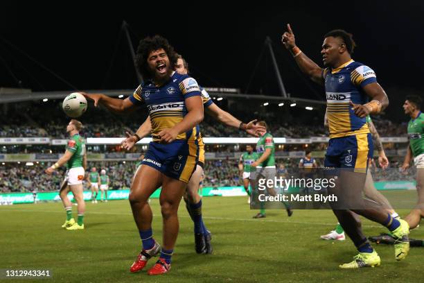Isaiah Papali'i of the Eels celebrates with team mates after scoring a try during the round six NRL match between the Canberra Raiders and the...