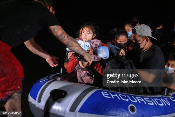 An immigrant child glances towards human trafficker while being smuggled into the United States from Mexico on April 15, 2021 in Roma, Texas. A surge...