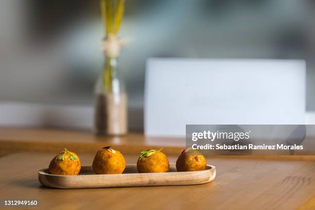 iberian ham croquettes, served on a wooden base - bechamelsoße stock-fotos und bilder