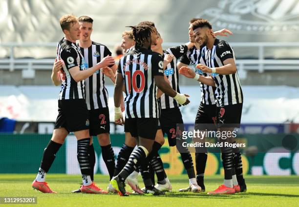 Joelinton of Newcastle United celebrates with teammates after scoring their team's second goal during the Premier League match between Newcastle...