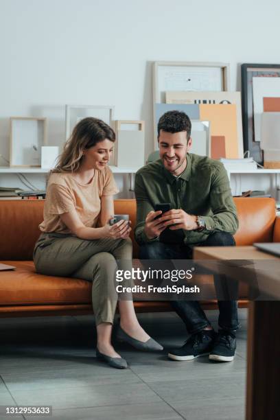 two colleagues enjoying a break from work - women in see through shirts stock pictures, royalty-free photos & images