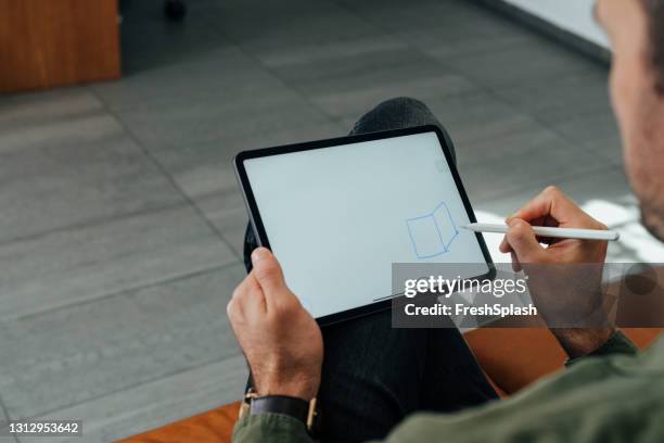 anonymous man using a digital tablet at work, a close up - drawing on tablet stock pictures, royalty-free photos & images
