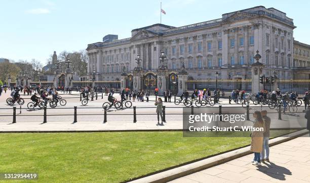 General view of cyclists passing Buckingham Palace on April 17, 2021 in London, England. The Duke of Edinburgh travelled extensively during his Royal...