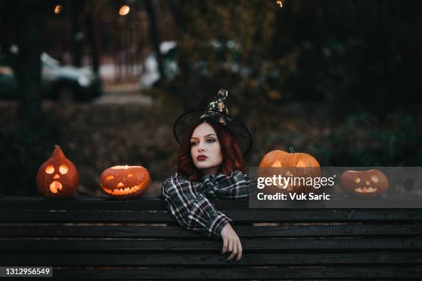 young woman with pumpkins - witch costume stock pictures, royalty-free photos & images