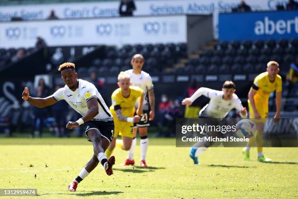 Jamal Lowe of Swansea City scores their team's first goal from the penalty spot during the Sky Bet Championship match between Swansea City and...