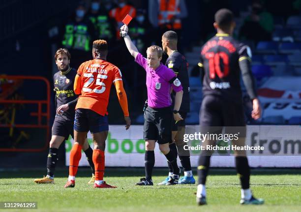 Kiko Femenia of Watford FC is shown a second yellow, followed by a red card and sent off by referee Gavin Ward during the Sky Bet Championship match...