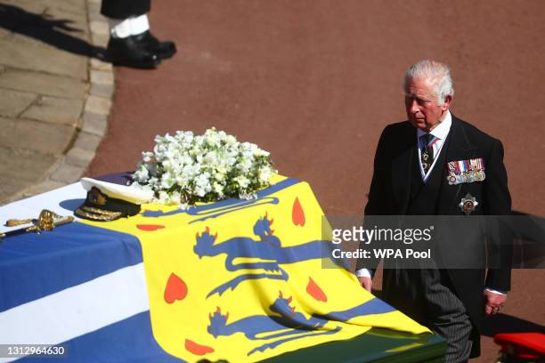 Prince Charles, Prince of Wales walks behind The Duke of Edinburgh’s coffin, covered with His Royal Highness’s Personal Standard, during the...