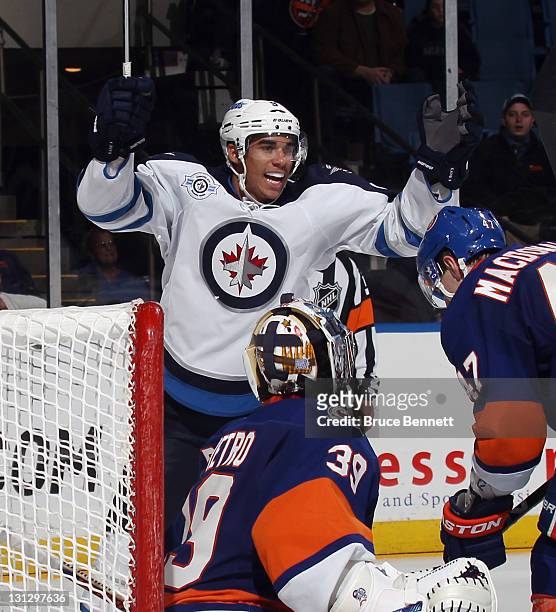 Evander Kane of the Winnipeg Jets celebrates a goal by Johnny Oduya at 16:04 of the third period against Rick DiPietro of the New York Islanders at...