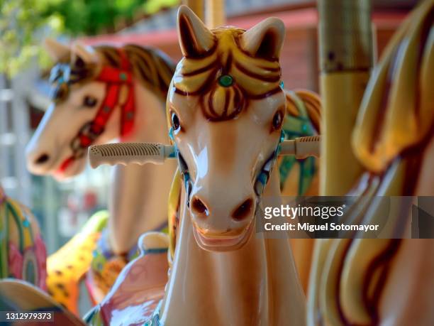 horses on a merry-go-round carousel - carousel horse stock pictures, royalty-free photos & images