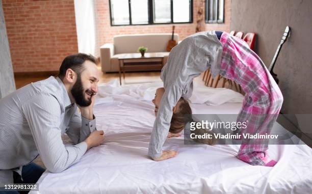 practising bending over backwards while dad watches - royalty free stock pictures, royalty-free photos & images