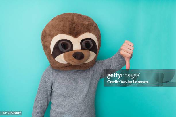 funny man in meerkat mask with thumbs down gesture. - daumen runter stock-fotos und bilder