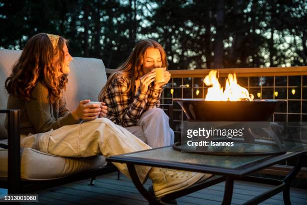 sisters by the fire - fire pit stock pictures, royalty-free photos & images