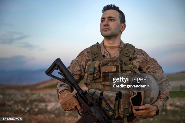 retrato de un soldado del ejército en el campo de batalla - personal militar fotografías e imágenes de stock