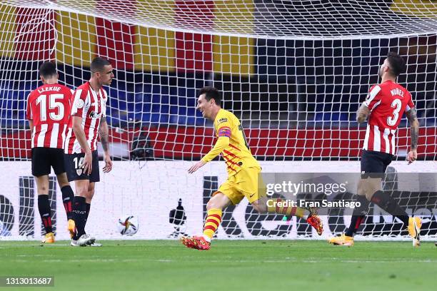 Lionel Messi of Barcelona celebrates scoring his sides third goal as players from Athletic Club stand dejected during the Copa del Rey Final match...