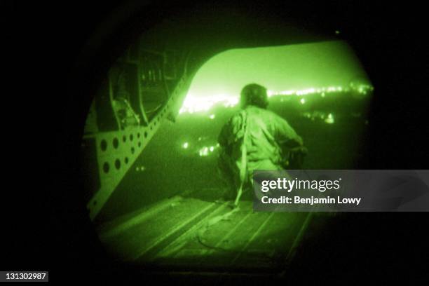 Helicopter tailgunner watches the passing Iraqi landscape for potential targets as soldiers with the 509th Infantry Division and the 3rd Infantry's...