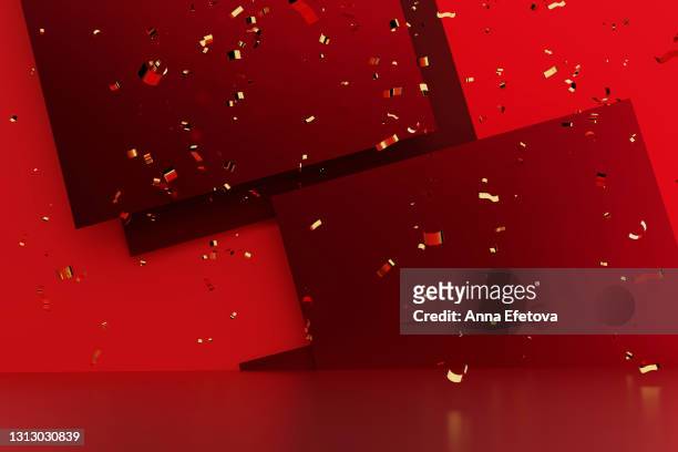 many gold confetti is falling down on red table against multi layered red paper background. front view. copy space for your design. christmas celebration concept - gold dust stock-fotos und bilder