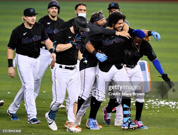 Miami Marlins celebrate the walk off single by Jorge Alfaro in the tenth inning to defeat the San Francisco Giants by score of 7-6 at loanDepot park...