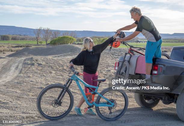 mountain biker couple load bikes on vehicle - glen haven co stock pictures, royalty-free photos & images