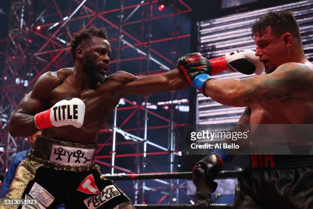 Steve Cunningham punches Frank Mir in their heavyweight bout during Triller Fight Club at Mercedes-Benz Stadium on April 17, 2021 in Atlanta, Georgia.