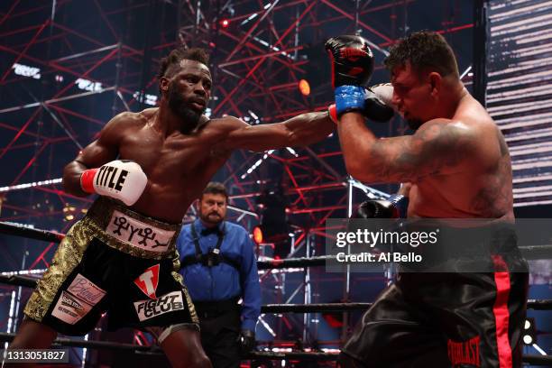 Steve Cunningham punches Frank Mir in their heavyweight bout during Triller Fight Club at Mercedes-Benz Stadium on April 17, 2021 in Atlanta, Georgia.