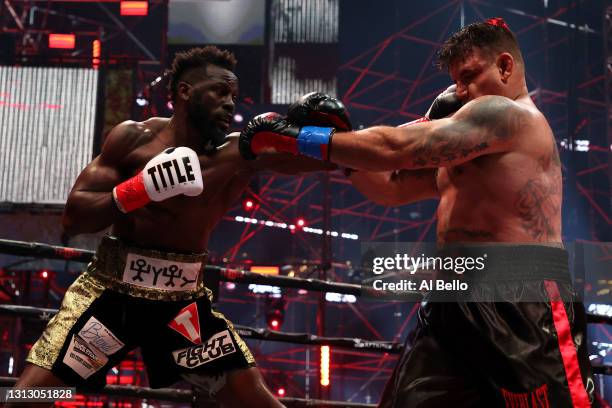 Steve Cunningham punches Frank Mir in their heavyweight bout during Triller Fight Club at Mercedes-Benz Stadium on April 17, 2021 in Atlanta, Georgia.