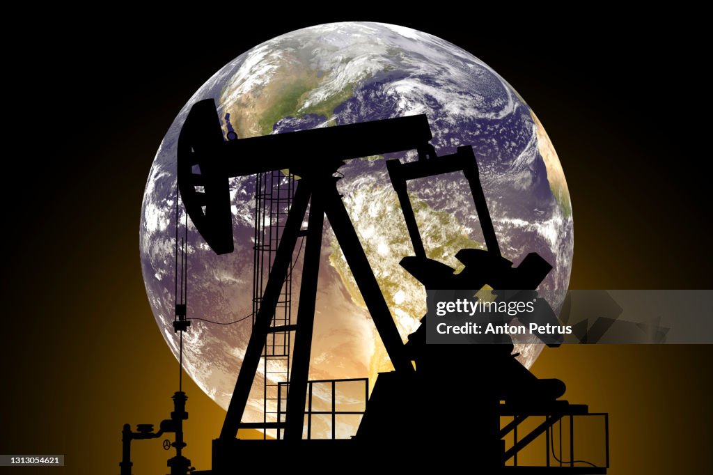 Oil pump on a planet Earth background. Concept of World Oil Industry