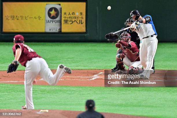 Sho Nakata of the Hokkaido Nippon Ham Fighters hits a two-run homer against Masahiro Tanaka of Tohoku Rakuten Golden Eagles in the 1st inniing at the...