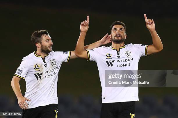 Loic Puyo of the Bulls celebrates scoring a goal with team mate Tommy Oar during the A-League match between Macarthur FC and the Newcastle Jets at...