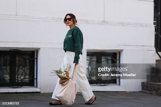 Elise Soho wearing beige Zara pants, Hey Soho sweater, Celine shades and Espadrij sandals and bag on April 16, 2021 in Hamburg, Germany.