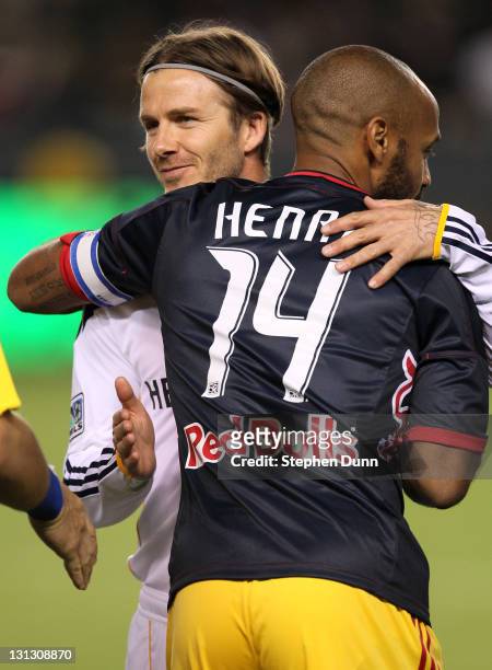 Thierry Henry of the New York Red Bulls and David Beckham of the Los Angeles Galaxy hug before playing in their Western Conference Semifinal at The...