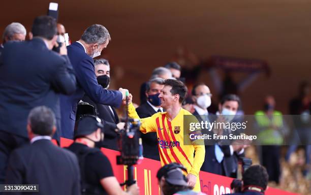 King Felipe VI congratulates Lionel Messi of FC Barcelona during the Copa del Rey Final match between Athletic Club and Barcelona at Estadio de La...