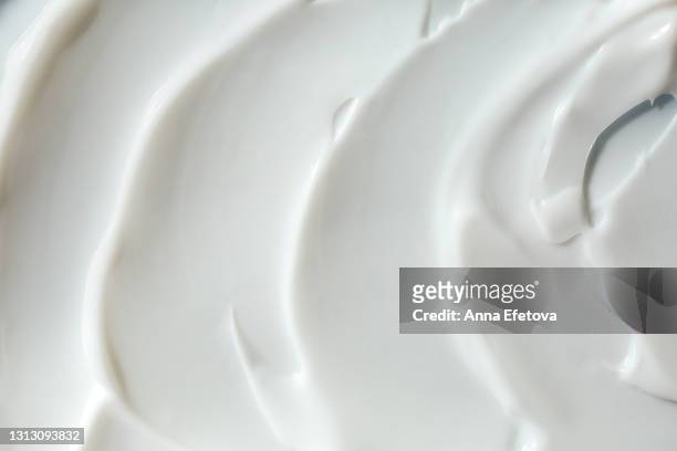 texture of smears of white yogurt or cream. good background for your design - coconut shaving stock pictures, royalty-free photos & images
