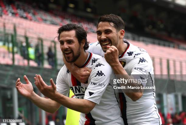 Mattia Destro of Genoa celebrates with Edoardo Goldaniga after scoring their team's first goal during the Serie A match between AC Milan and Genoa...