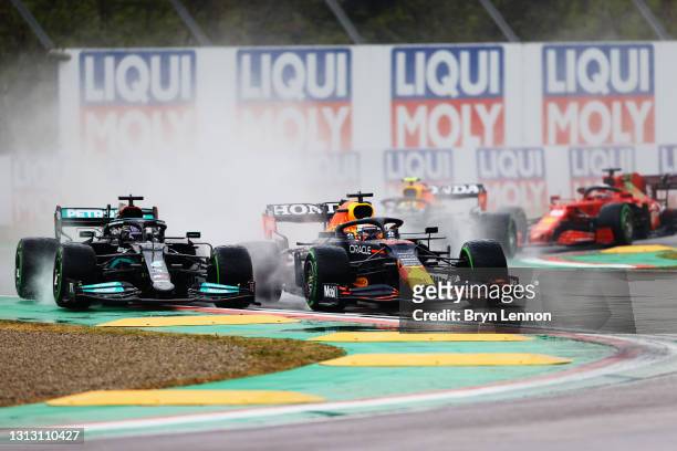 Lewis Hamilton of Great Britain driving the Mercedes AMG Petronas F1 Team Mercedes W12 and Max Verstappen of the Netherlands driving the Red Bull...