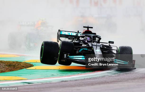 Lewis Hamilton of Great Britain driving the Mercedes AMG Petronas F1 Team Mercedes W12 launches off a raised kerb during the F1 Grand Prix of Emilia...