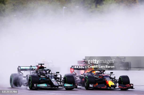 Lewis Hamilton of Great Britain driving the Mercedes AMG Petronas F1 Team Mercedes W12 and Max Verstappen of the Netherlands driving the Red Bull...