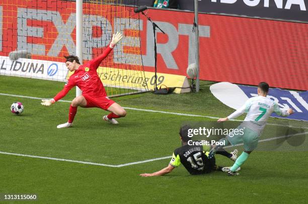 Milot Rashica of Werder Bremen scores their team's first goal past Marwin Hitz of Borussia Dortmund during the Bundesliga match between Borussia...