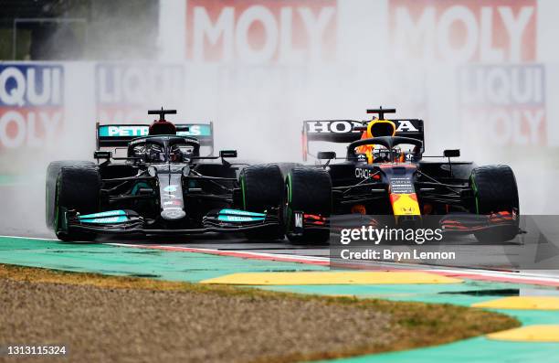 Lewis Hamilton of Great Britain driving the Mercedes AMG Petronas F1 Team Mercedes W12 and Max Verstappen of the Netherlands driving the Red Bull...