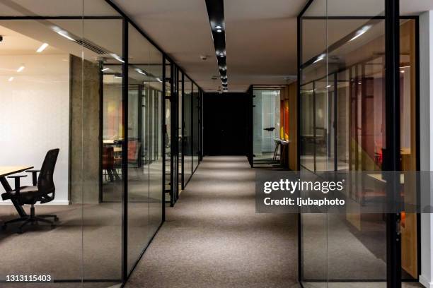 empty corridor in modern office building at night - travel agency stock pictures, royalty-free photos & images