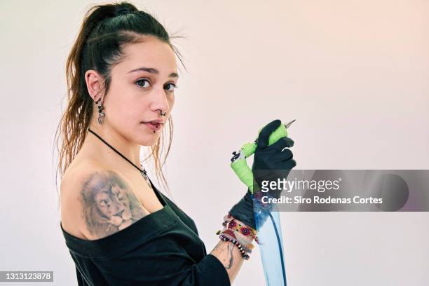 portrait of woman with lion tattoo - lion tattoo stock pictures, royalty-free photos & images
