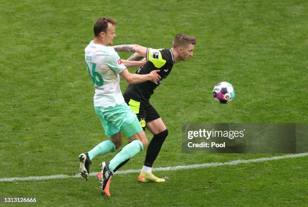 Marco Reus of Borussia Dortmund is challenged by Christian Gross of Werder Bremen during the Bundesliga match between Borussia Dortmund and SV Werder...